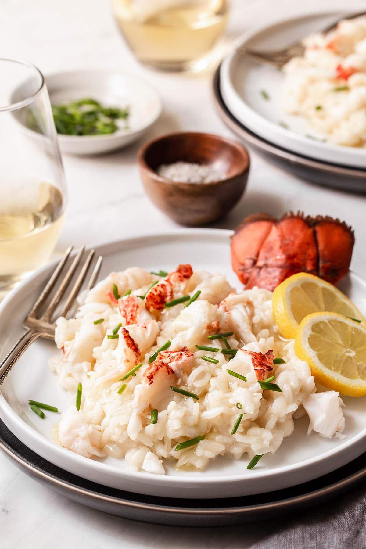 Risotto all'astice nel piatto con coda d'astice in cima.