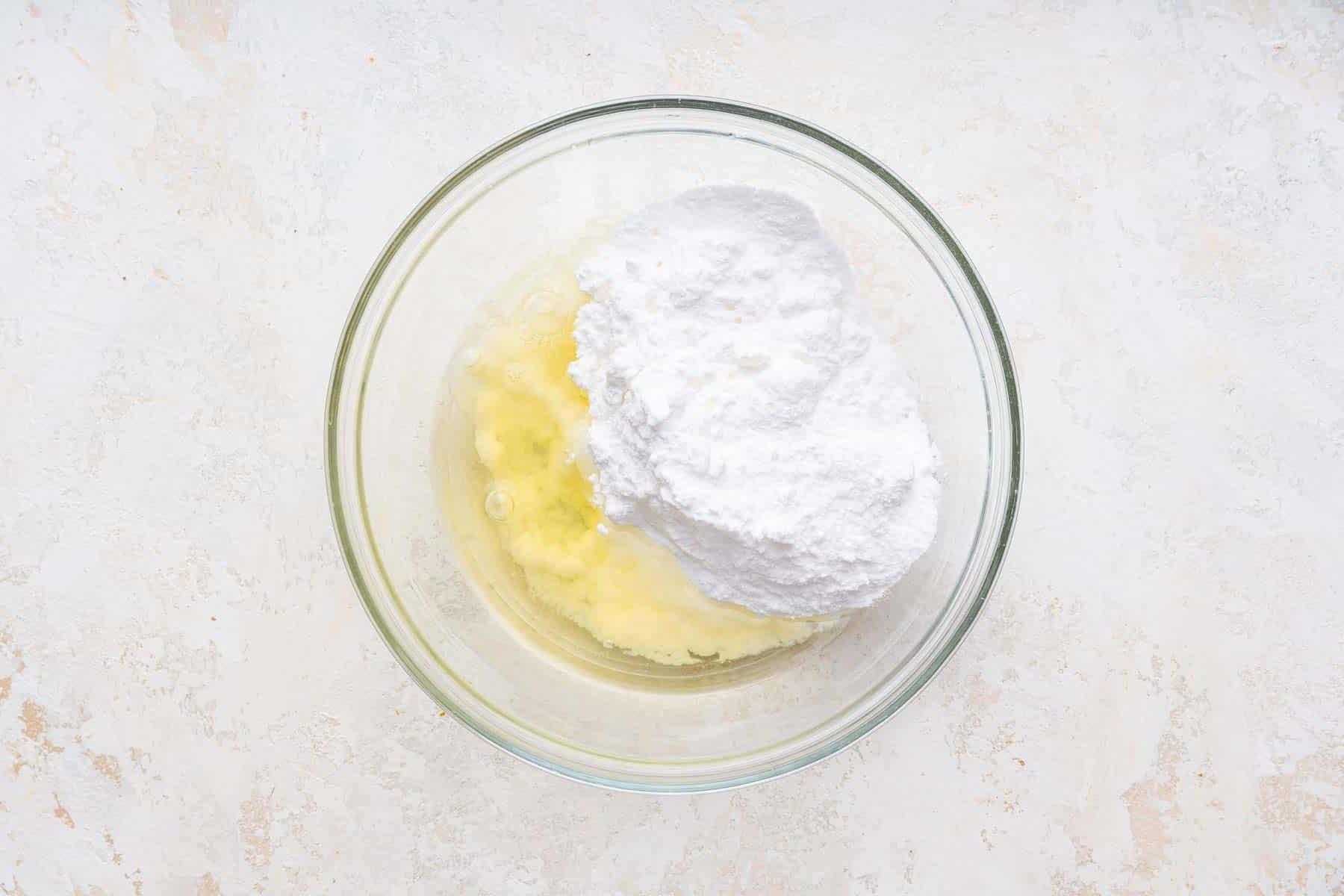 Biscotti Ciambella 11 Egg white, powdered sugar and lemon juice in clear glass bowl.