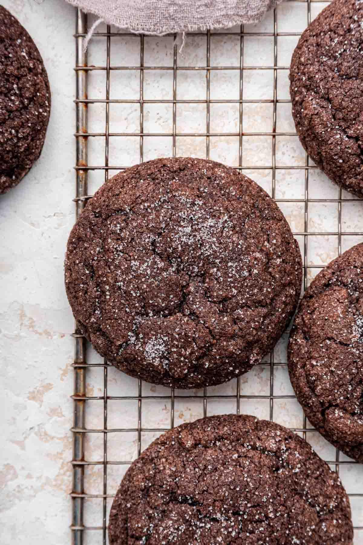 Overhead shot of chocolate sugar cookies on metal cooling rack.