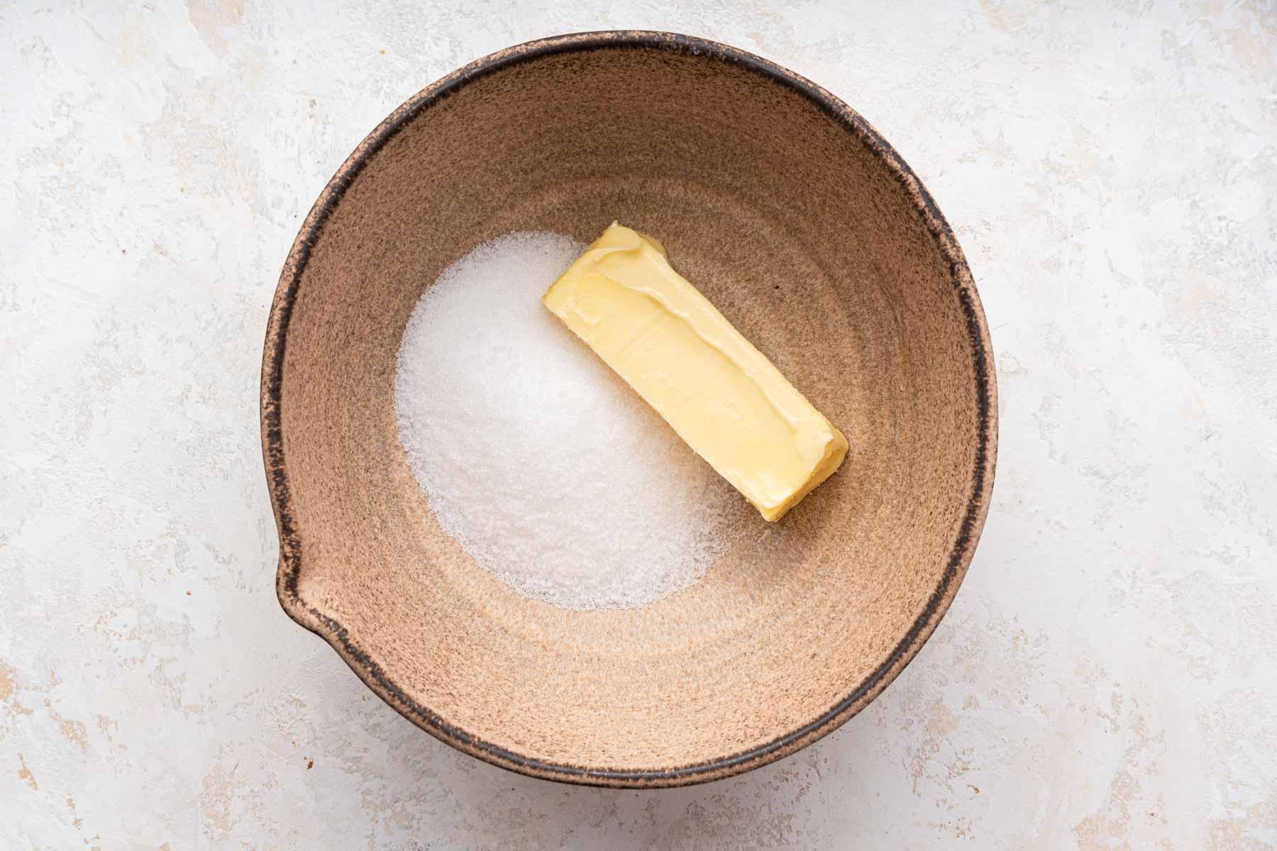 Biscotti Ciambella 5 One stick of butter and granulated sugar in brown mixing bowl.