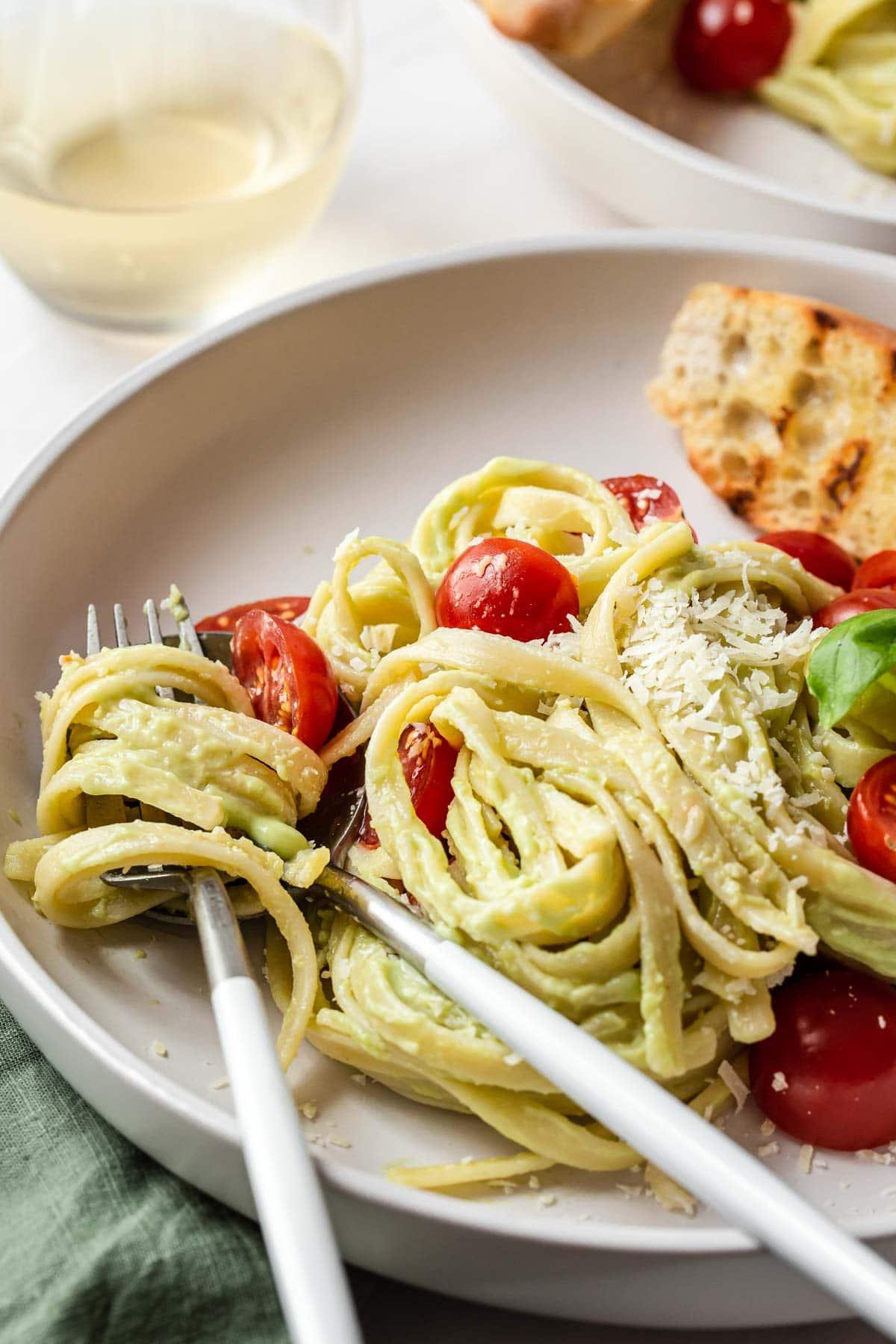 Fork in pasta noodles on plate.