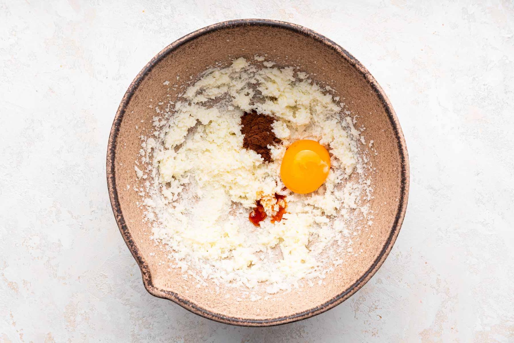 Bowl with fluffy butter, egg, vanilla and espresso powder.