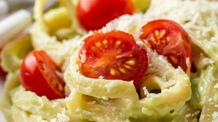 Avocado sauce on noodles with cherry tomatoes.