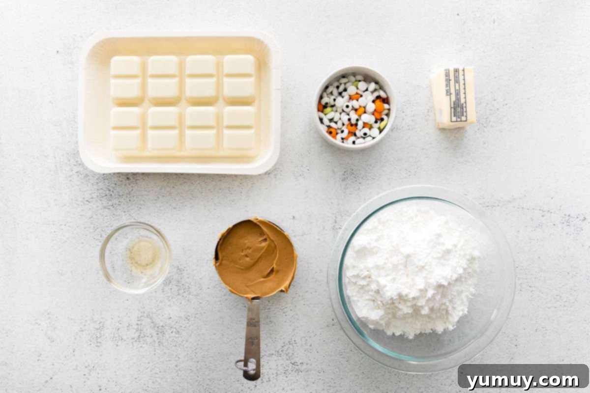 Ingredients for Halloween white chocolate buckeyes laid out on a table.