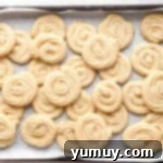 Pure Butter Delights 9 A baking tray filled with freshly baked, golden-brown butter cookies.