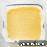 Haunted Fudge Delights 7 Step-by-step photos for how to make Halloween fudge, showing white chocolate fudge spread into a square baking dish.