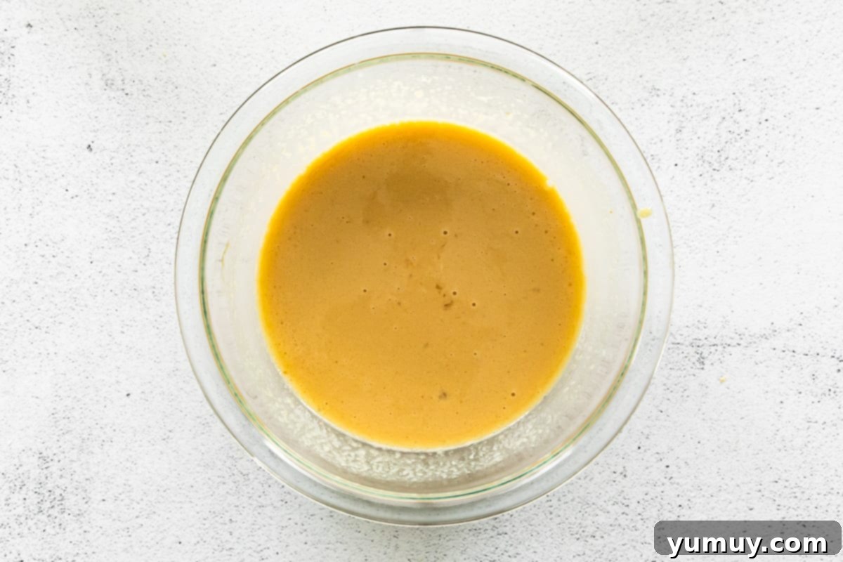 wet ingredients for apple cupcakes in a glass bowl
