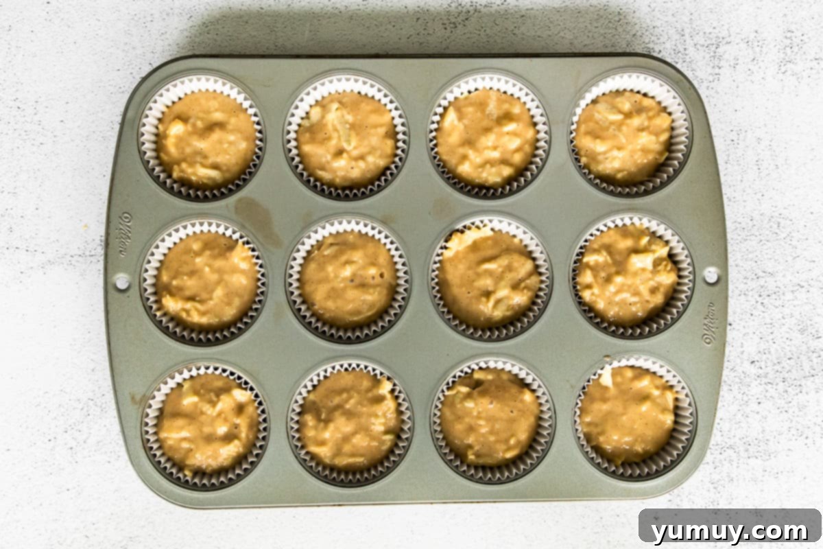 apple cupcake batter in cupcake pan before baking