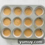 Pecan pie cupcake batter in a cupcake pan before baking