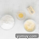 Cannoli Dream Cupcakes 8 Beating butter and mascarpone in a stand mixer for the frosting of cannoli cupcakes.