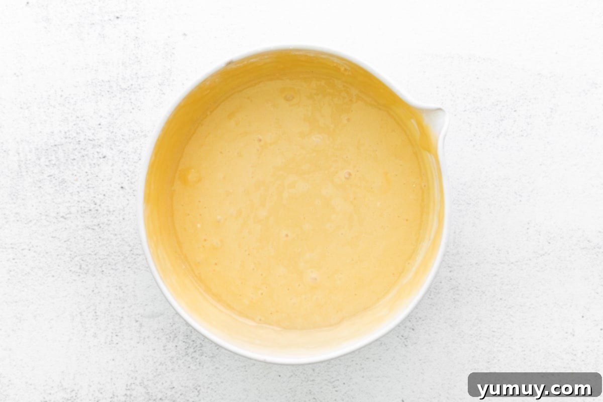 Cannoli Dream Cupcakes 10 Step-by-step image showing how to mix ingredients for cannoli cupcakes.