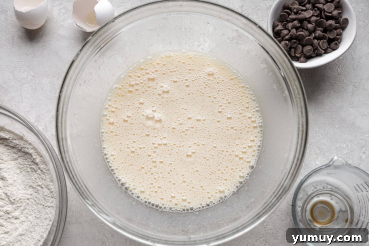 Ultimate Chocolate Chip Cupcakes 8 A blend of milk, eggs, and pure vanilla extract expertly mixed into the oil and sugar base, forming a smooth and harmonious wet batter.