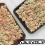 Step 4: Spreading and sprinkling Chex Mix with red and green sprinkles on a baking sheet.