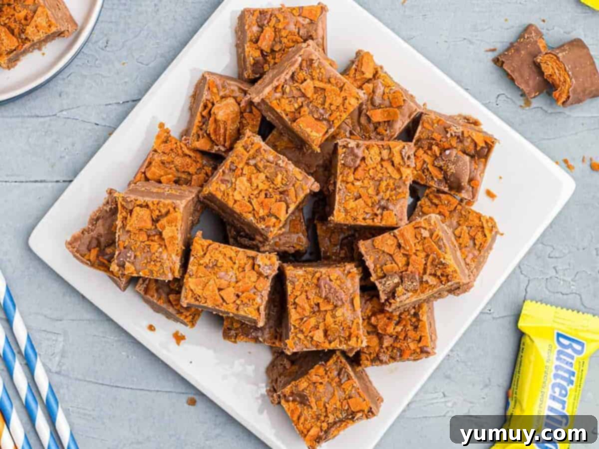 Butterfinger Bliss Fudge 16 Plate filled with perfectly sliced Butterfinger fudge squares, ready to enjoy