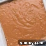 Butterfinger Bliss Fudge 8 Butterfinger fudge setting in a pan, with optional crushed candy topping