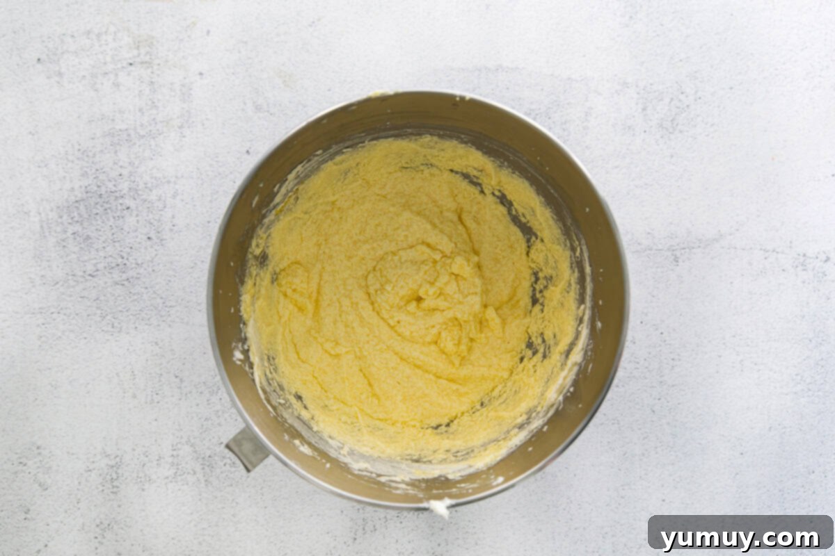 Classic Vanilla Pound Cake 13 yellow batter in a stainless mixing bowl.