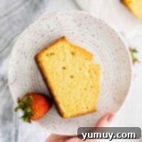 Classic Vanilla Pound Cake 4 overhead view of a slice of vanilla pound cake on a white plate with a strawberry.