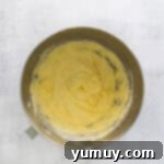 Classic Vanilla Pound Cake 7 yellow batter in a stainless mixing bowl.