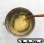 Classic Vanilla Pound Cake 8 vanilla pound cake batter in a stainless mixing bowl with a rubber spatula.