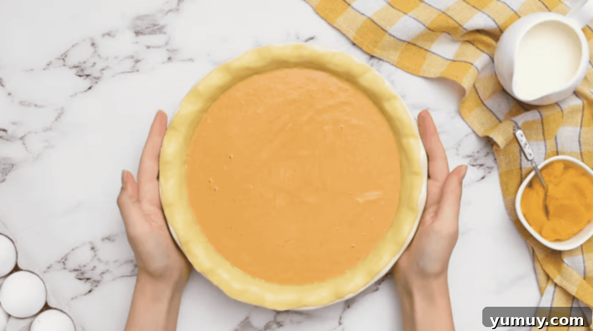 unbaked pumpkin pie in a pie pan.