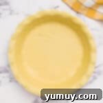 pie dough pressed into a pie pan.