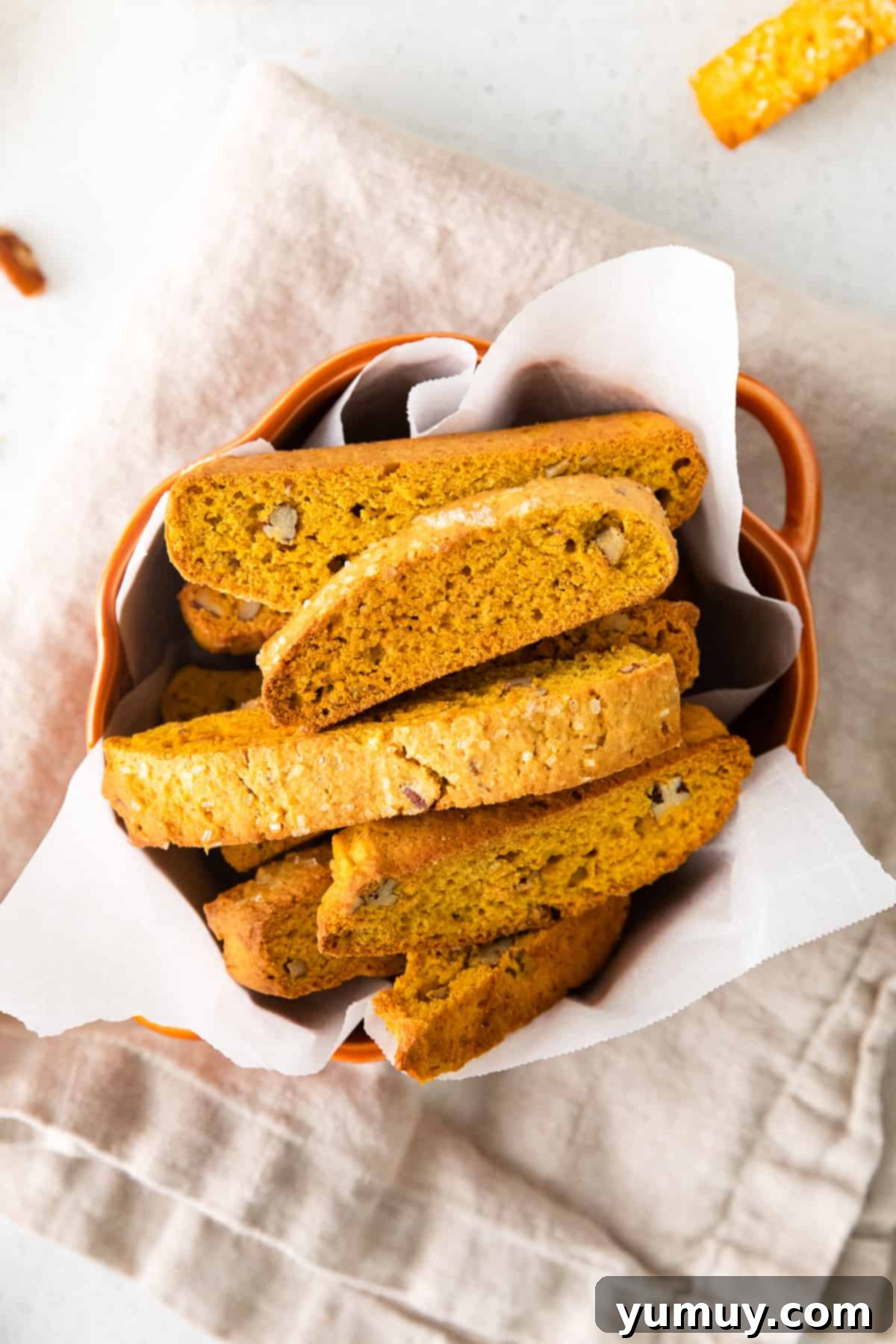 pumpkin pecan biscotti in an orange serving bowl