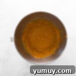 wet ingredients for pumpkin pecan biscotti in a metal bowl