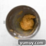 pumpkin pecan biscotti dough in a metal bowl