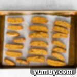 pumpkin pecan biscotti on a baking sheet after baking