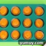 pumpkin cupcake batter in a cupcake pan before baking