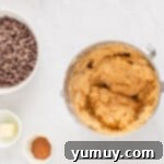 Peanut butter confection being mixed in a stainless steel mixing bowl.