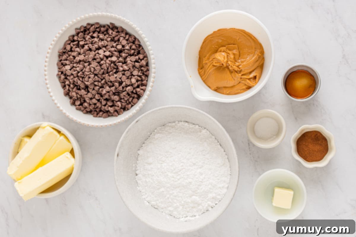 Overhead view of all pre-measured ingredients laid out on a counter, ready to make buckeye candy.