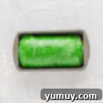 Unbaked Christmas swirl bread dough in a loaf pan, risen and ready for the oven