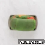 Freshly baked Christmas swirl bread in a loaf pan, cooling on a rack