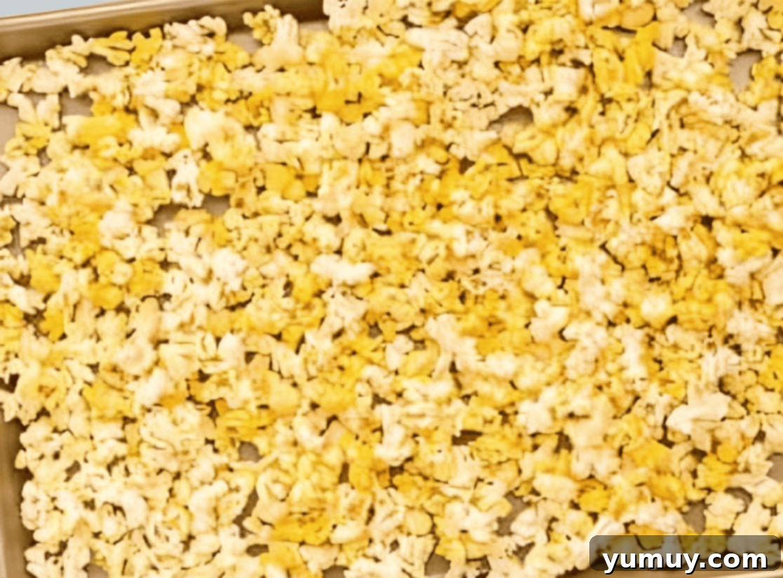 Golden Caramel Crunch 12 popcorn on a baking sheet.