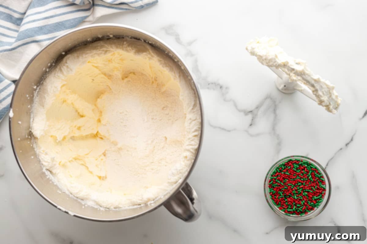 sugar cookie dough and red and green sprinkles in bowls