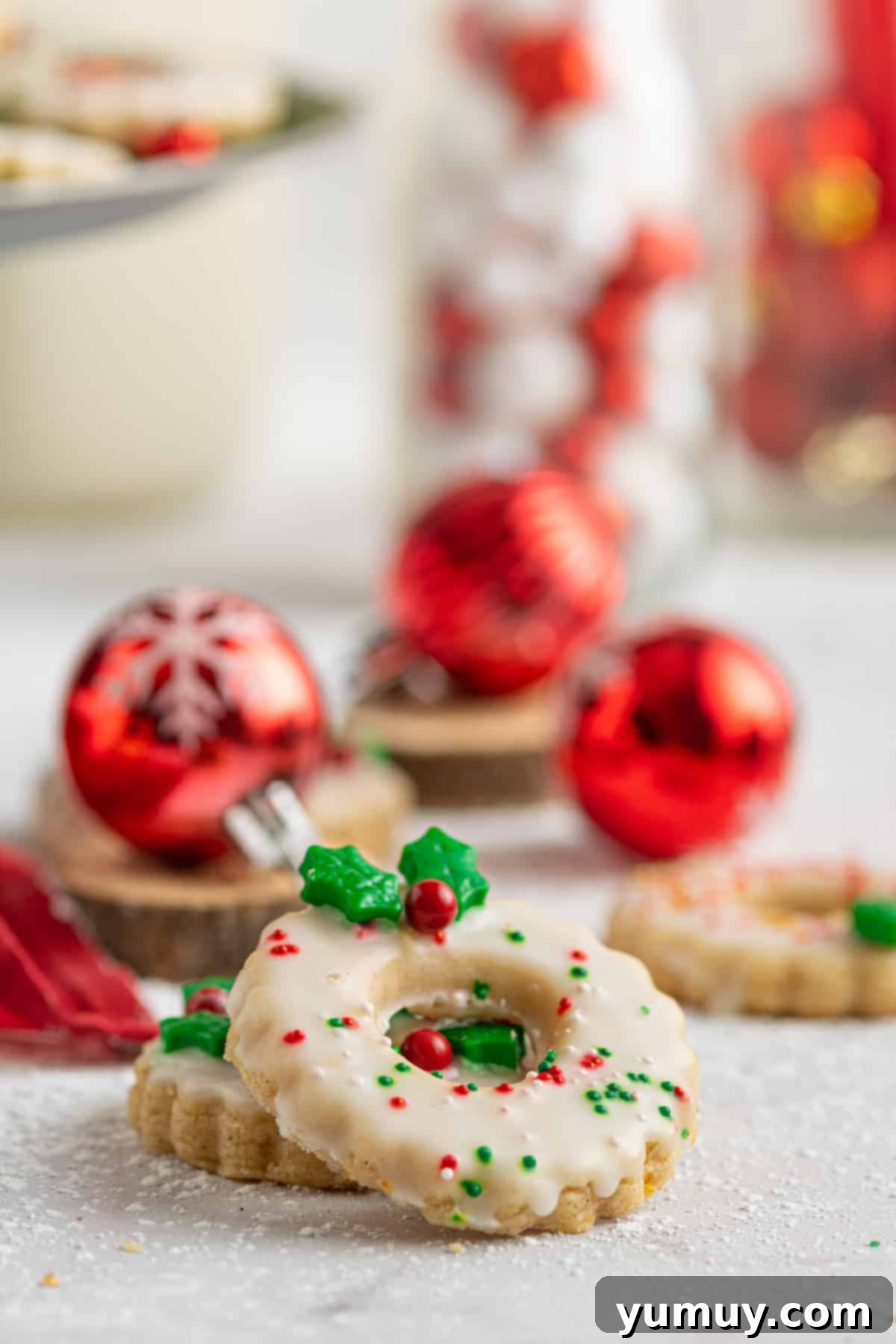 Holiday Wreath Delights 4 A festive holiday tablescape featuring beautifully decorated Christmas wreath cookies, ready for serving.