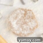 Festive Gingerbread Treats 11 A floured disc of chilled gingerbread cookie dough on a clean surface.