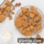 Festive Gingerbread Treats 14 Baked gingerbread cookies cooling on a round wire rack after being removed from the oven.