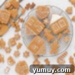 Festive Gingerbread Treats 17 Decorated gingerbread cookies with white royal icing designs, setting on a cooling rack.