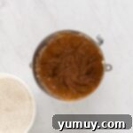 Festive Gingerbread Treats 8 Wet ingredients for gingerbread cookies blended into the creamed butter and sugar in a stainless mixing bowl.