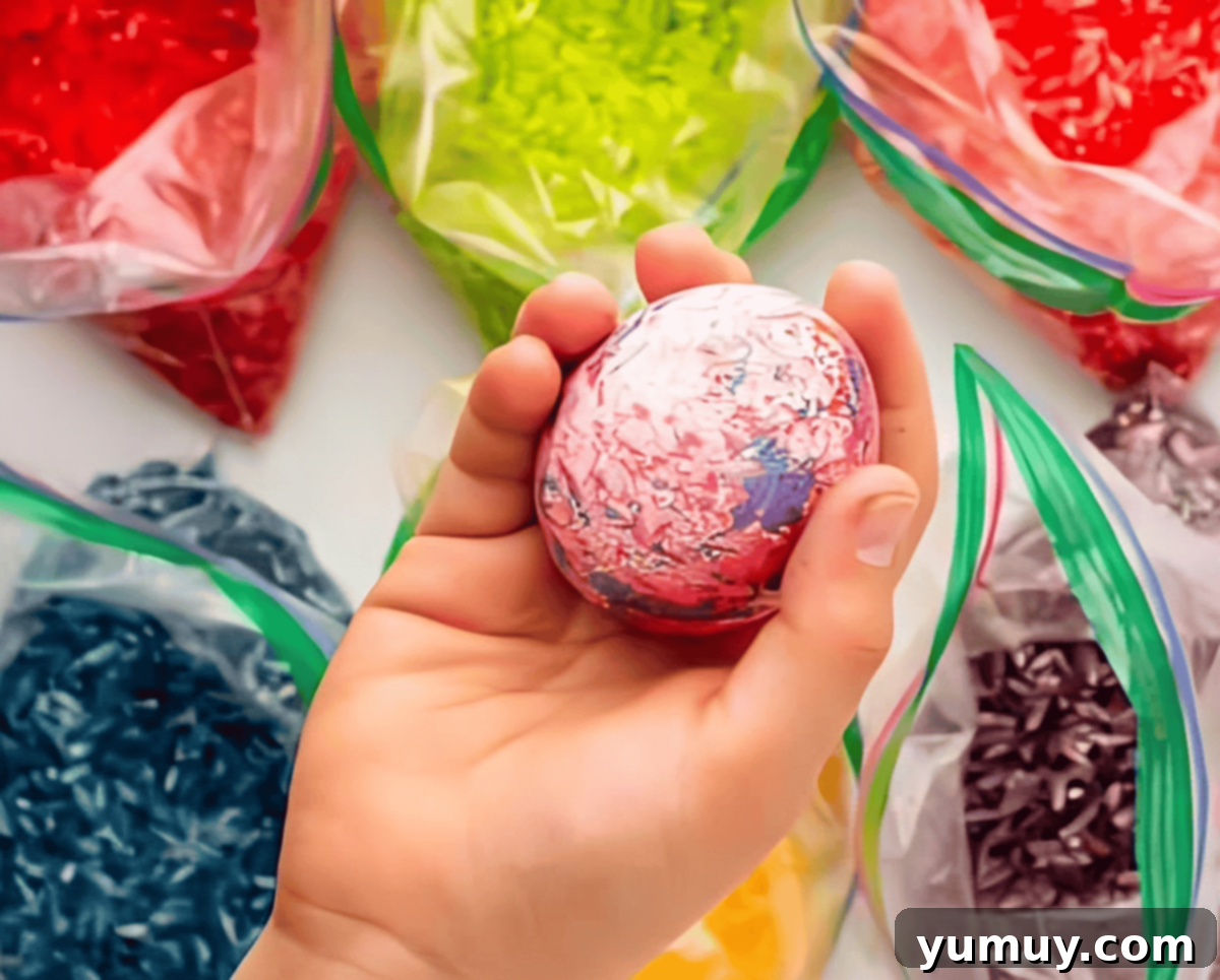 holding a rice dyed easter egg to show the colors.