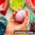 holding a rice dyed easter egg to show the colors.