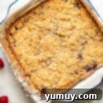 Luscious Raspberry Bars 8 Baking dish with golden-brown raspberry crumb bars, fresh from the oven.