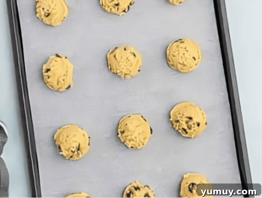 chocolate chip cookie dough balls on a baking sheet.