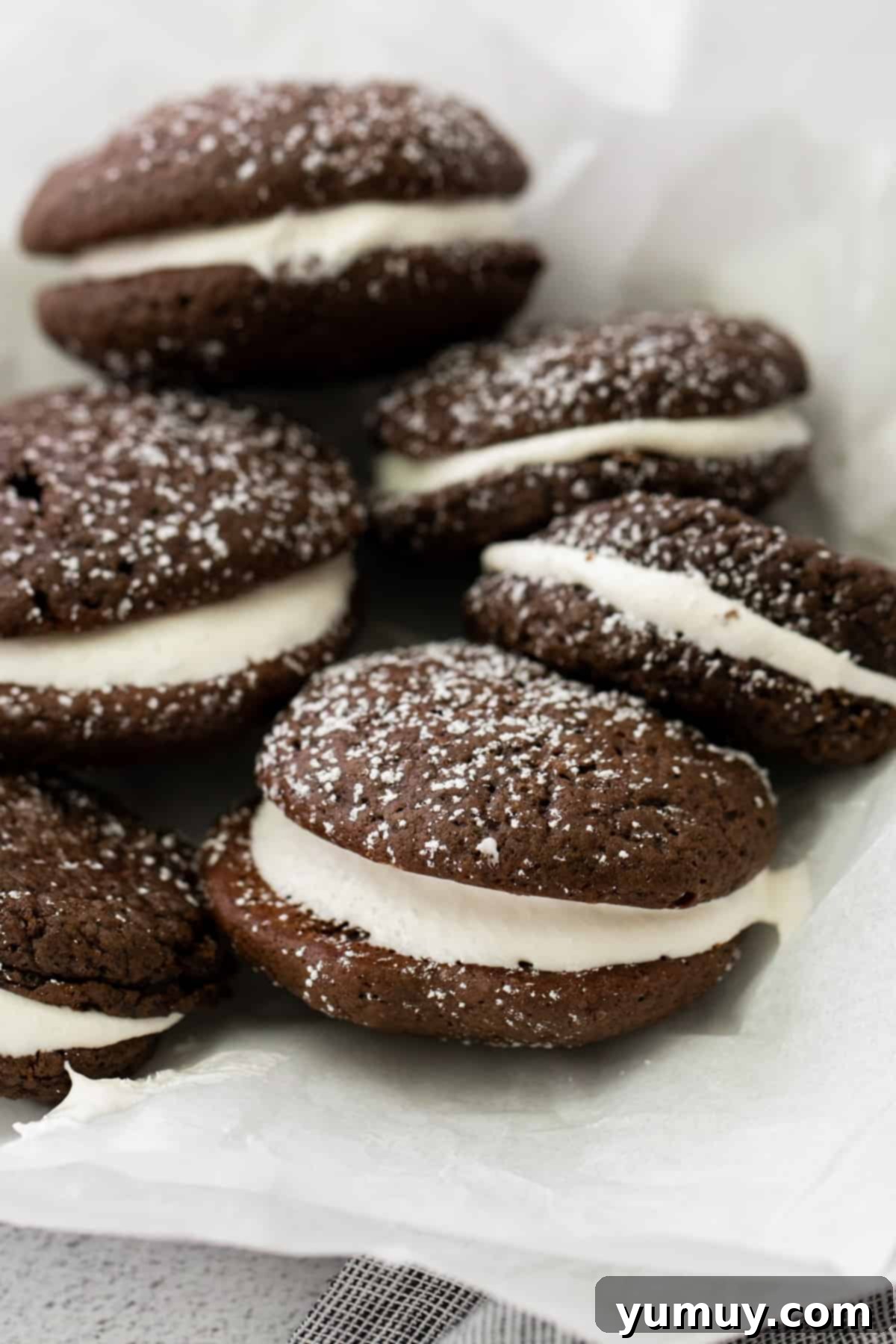 Close-up of freshly baked cake mix whoopie pies, lightly dusted with powdered sugar, creating an inviting visual.