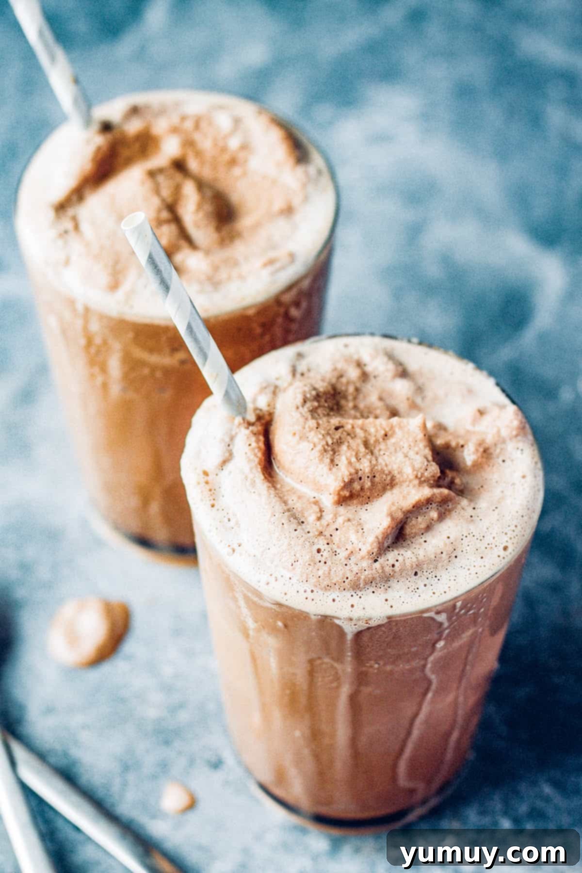 Make Your Own Wendy's Chocolate Frosty at Home 2 Two glasses of homemade chocolate frosty drinks with straws, ready to be enjoyed.