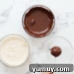 Bite Sized Chocolate Delights 14 Holding a chocolate coated cake pop to dry.