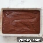 Bite Sized Chocolate Delights 6 Chocolate cake batter spread into a baking pan.