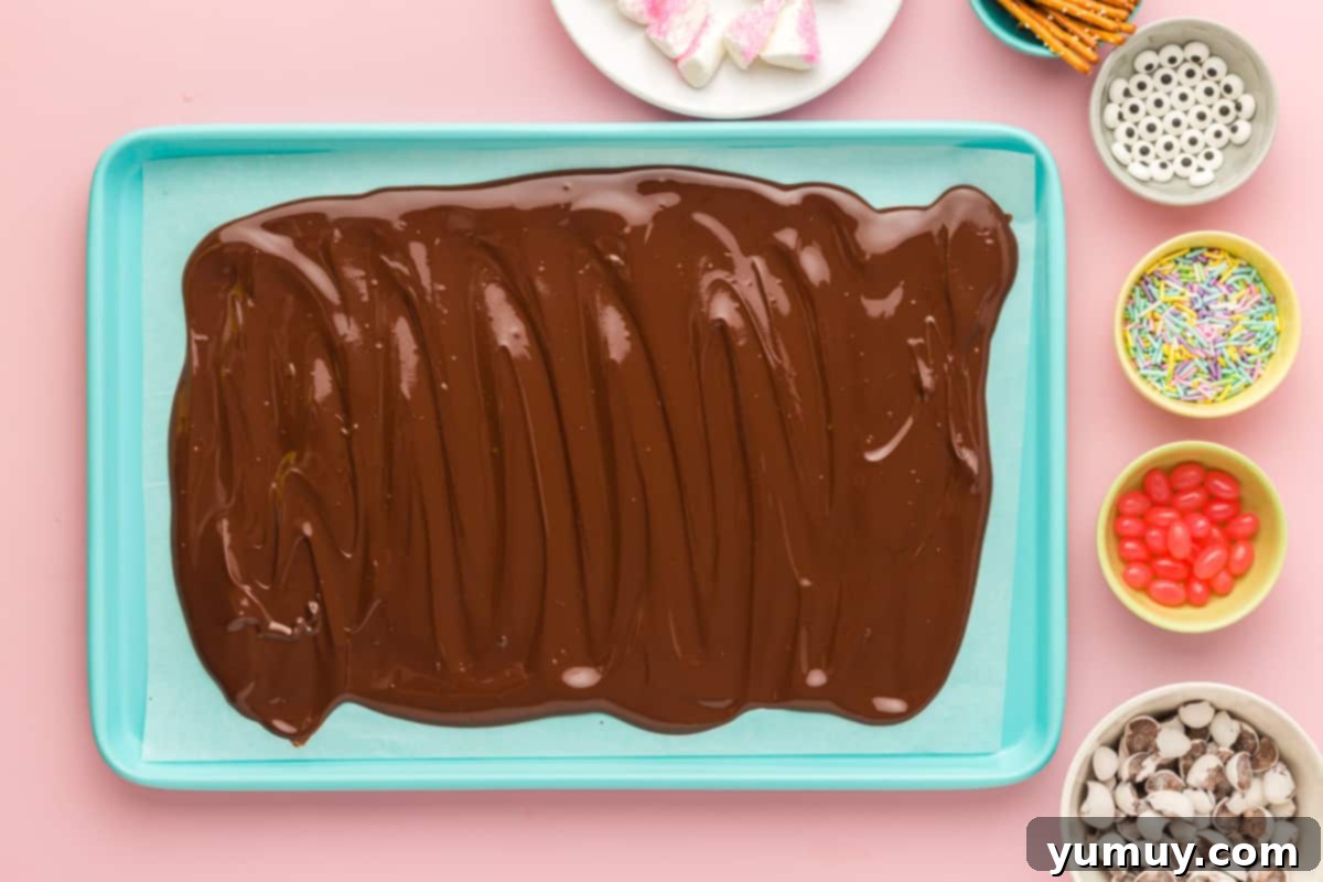 smooth, melted chocolate spread evenly on parchment paper on a baking sheet